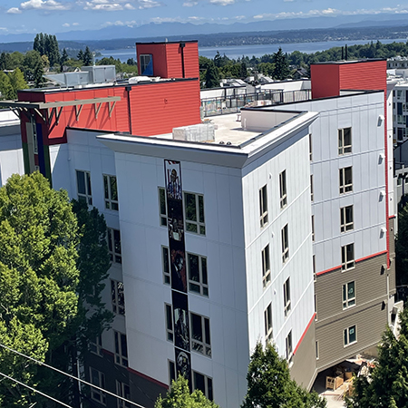 An exterior aria photo of Central District Freehold with Lake Washington in the distance.